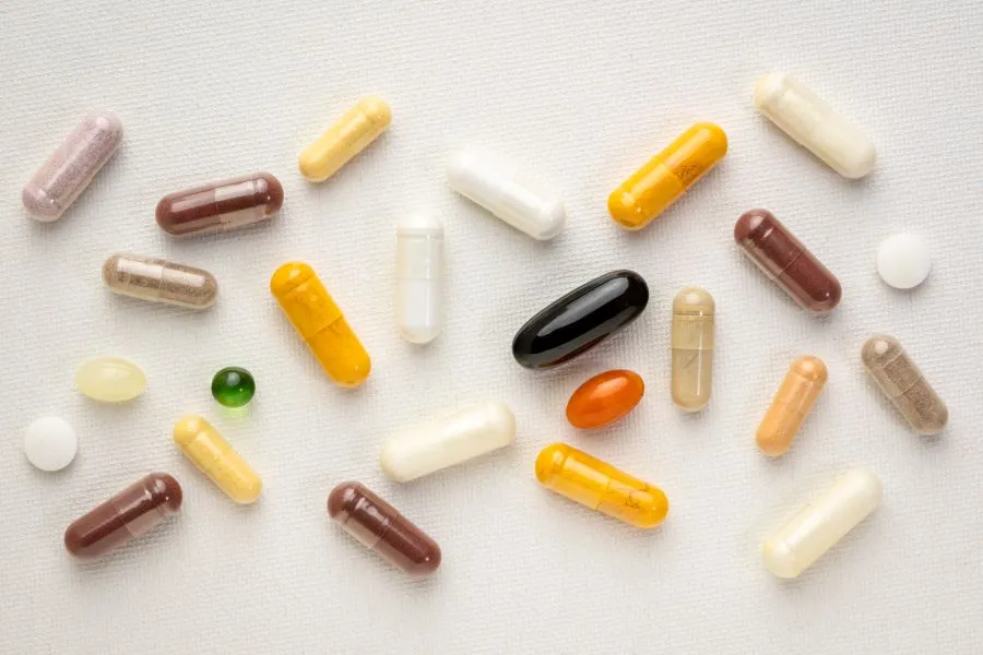 A bunch of different supplements on a white tablecloth.